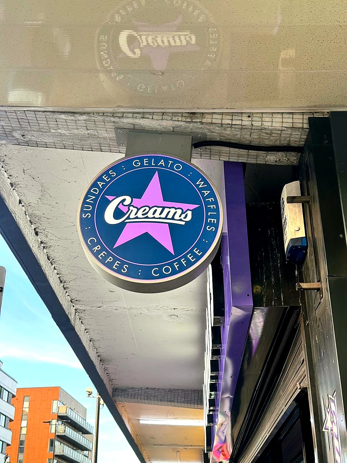 Creams projecting circular sign