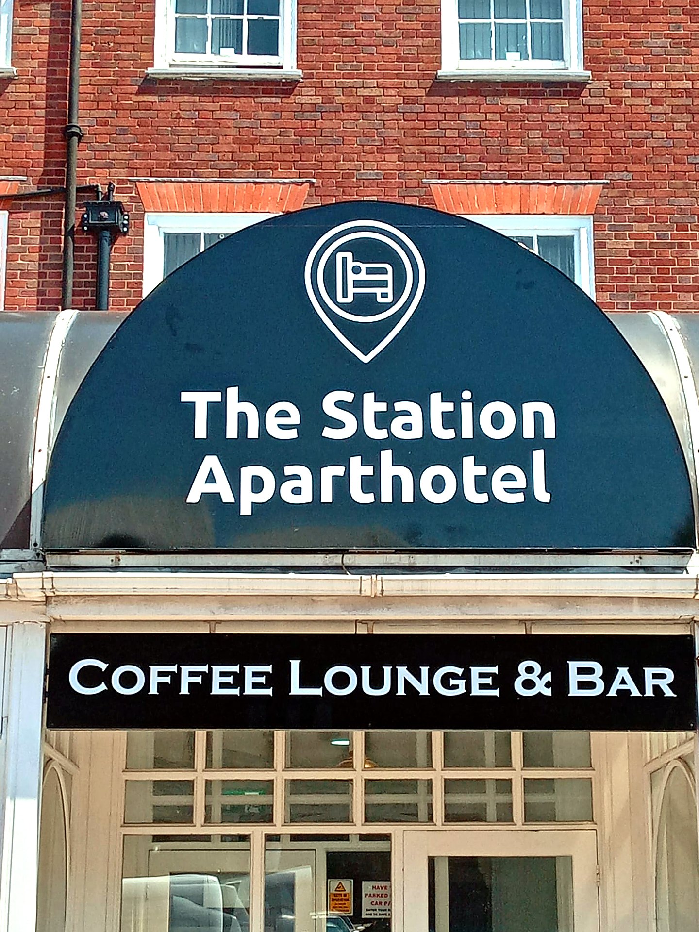 The Station Aparthotel illuminated sign